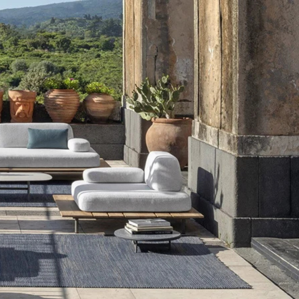 Ethimo Italian outdoor furniture in teak and refined finishes, displayed at Royal Interiors Singapore showroom