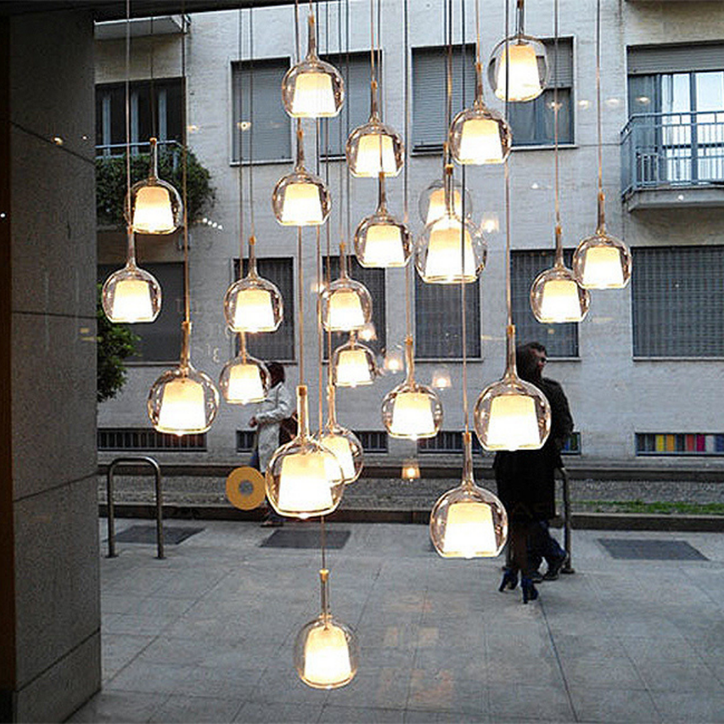 Penta Italian designer lighting featuring sculptural mirrored floor and pendant lights displayed in a luxury Singapore showroom