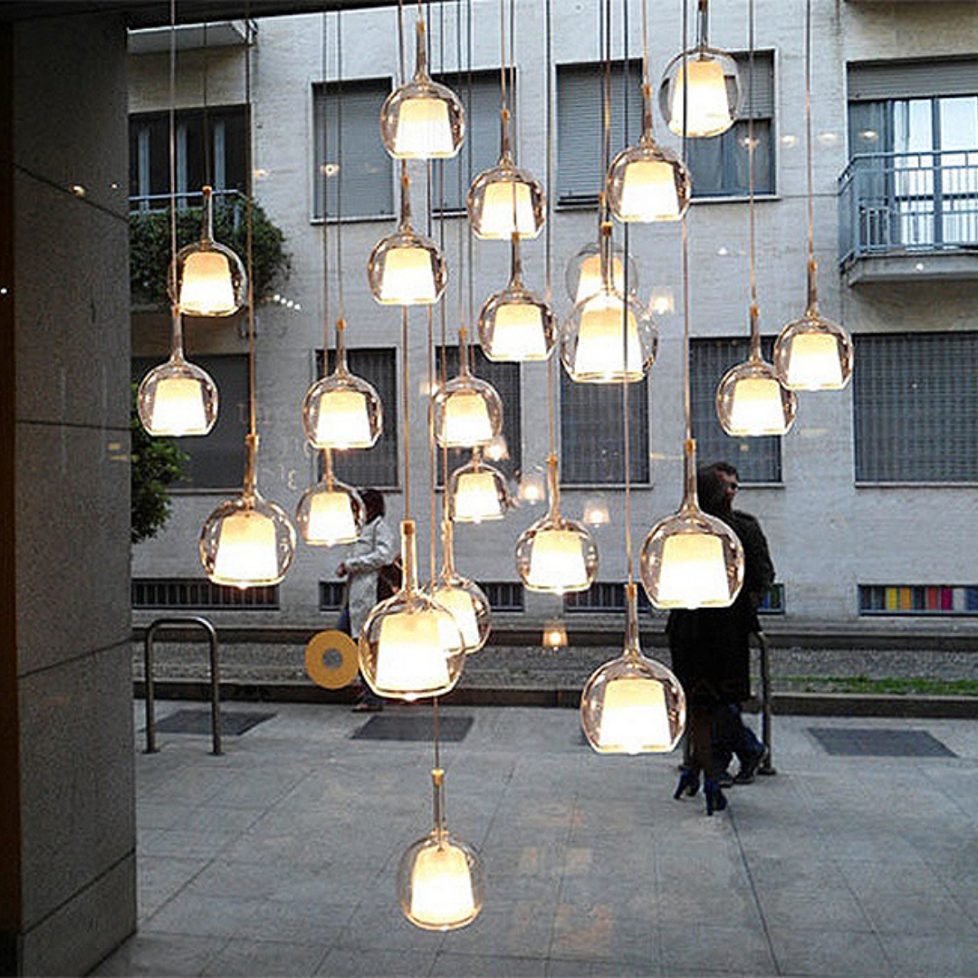 Penta Italian designer lighting featuring sculptural mirrored floor and pendant lights displayed in a luxury Singapore showroom