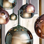 Penta Italian designer lighting featuring sculptural mirrored floor and pendant lights displayed in a luxury Singapore showroom