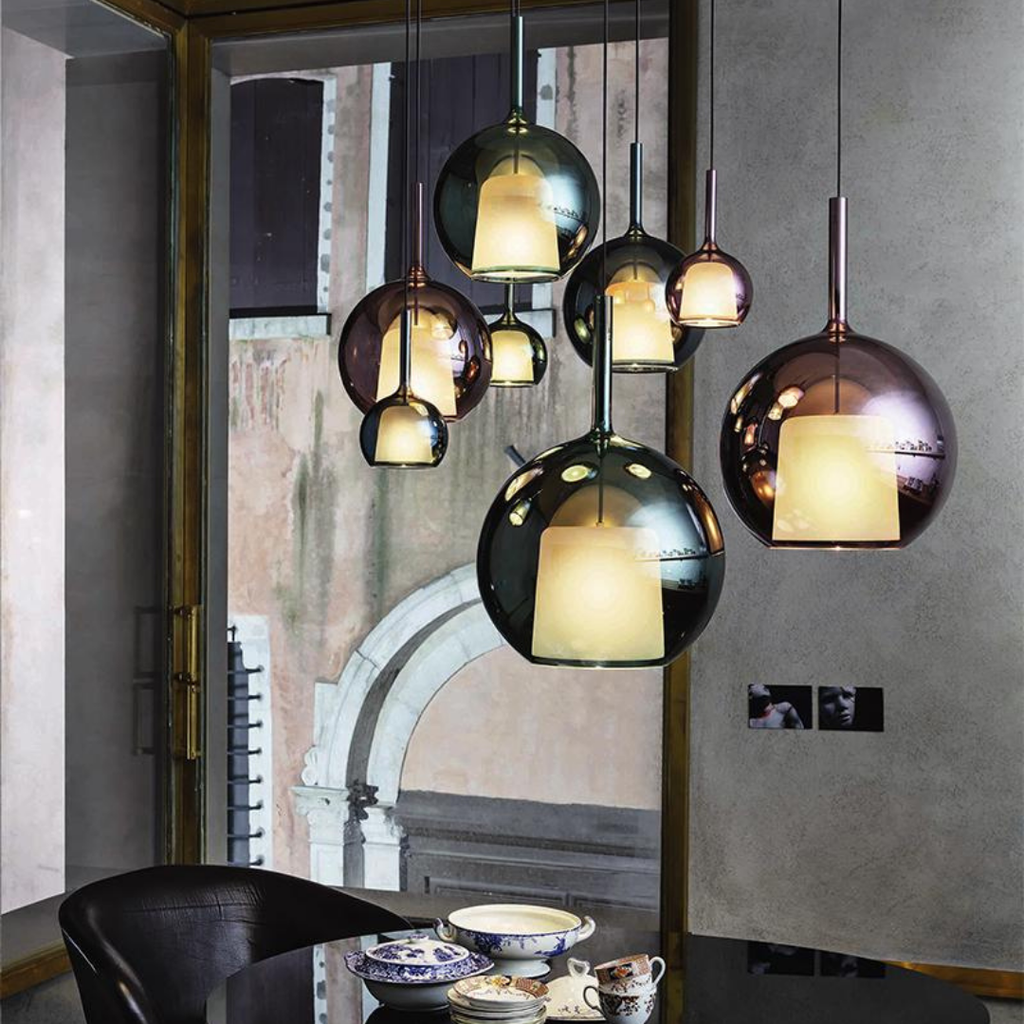 Penta Italian designer lighting featuring sculptural mirrored floor and pendant lights displayed in a luxury Singapore showroom