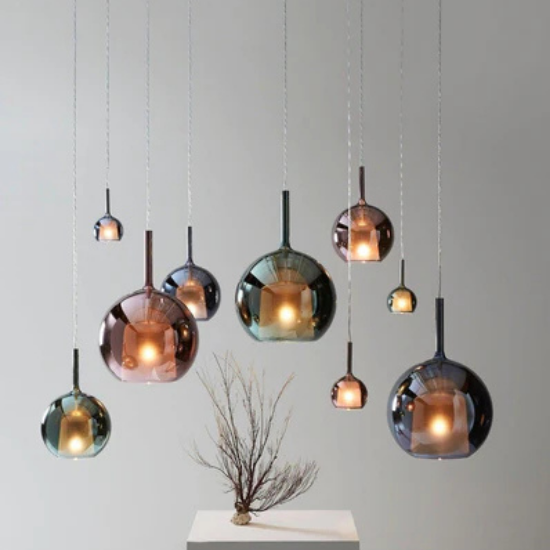 Penta Italian designer lighting featuring sculptural mirrored floor and pendant lights displayed in a luxury Singapore showroom