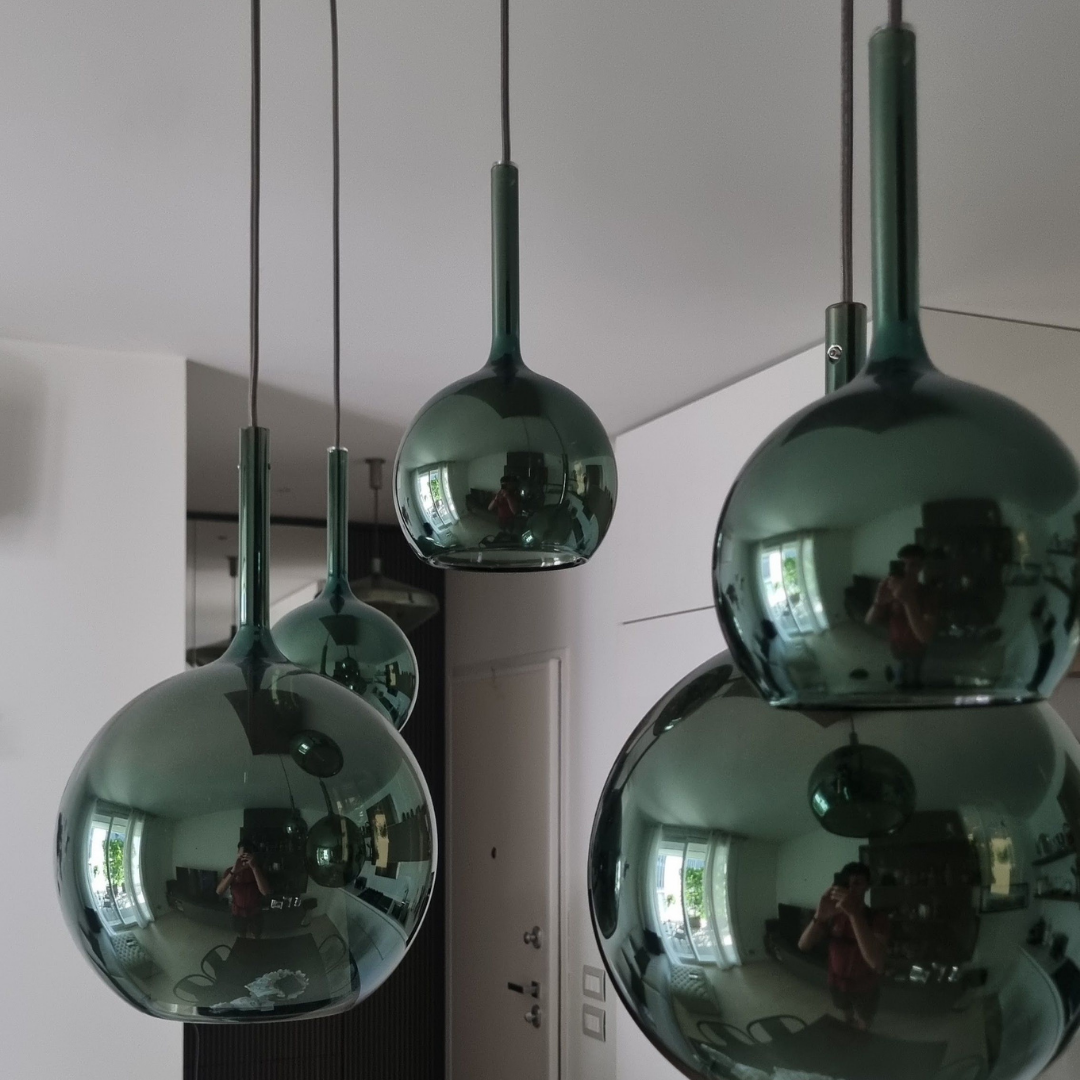 Penta Italian designer lighting featuring sculptural mirrored floor and pendant lights displayed in a luxury Singapore showroom