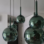 Penta Italian designer lighting featuring sculptural mirrored floor and pendant lights displayed in a luxury Singapore showroom