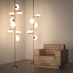 Penta Italian designer lighting featuring sculptural mirrored floor and pendant lights displayed in a luxury Singapore showroom