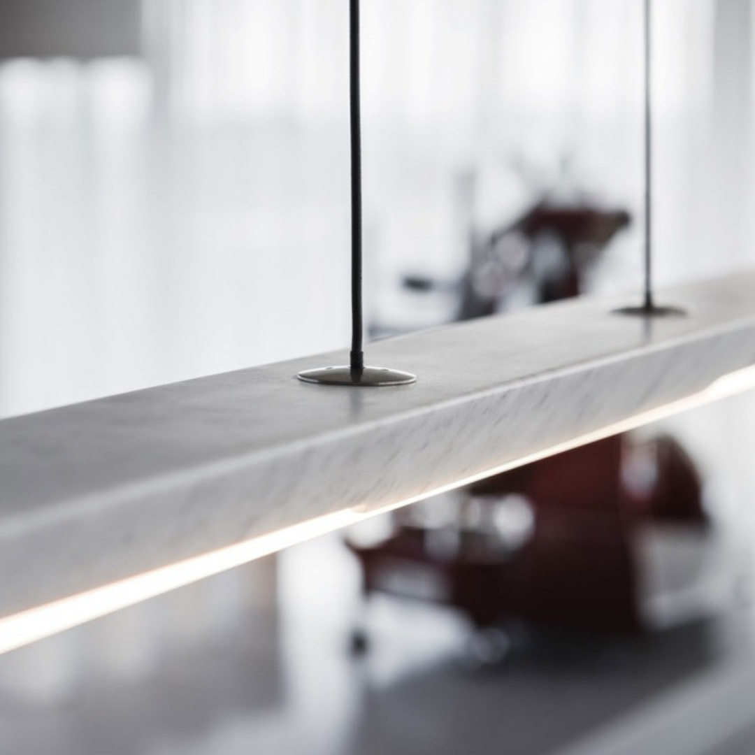 Penta Italian designer lighting featuring sculptural mirrored floor and pendant lights displayed in a luxury Singapore showroom