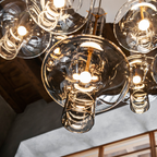 Penta Italian designer lighting featuring sculptural mirrored floor and pendant lights displayed in a luxury Singapore showroom