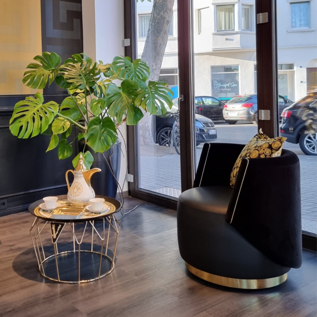 Versace Home furniture with signature Medusa and La Greca detailing, available at Royal Interiors Singapore.