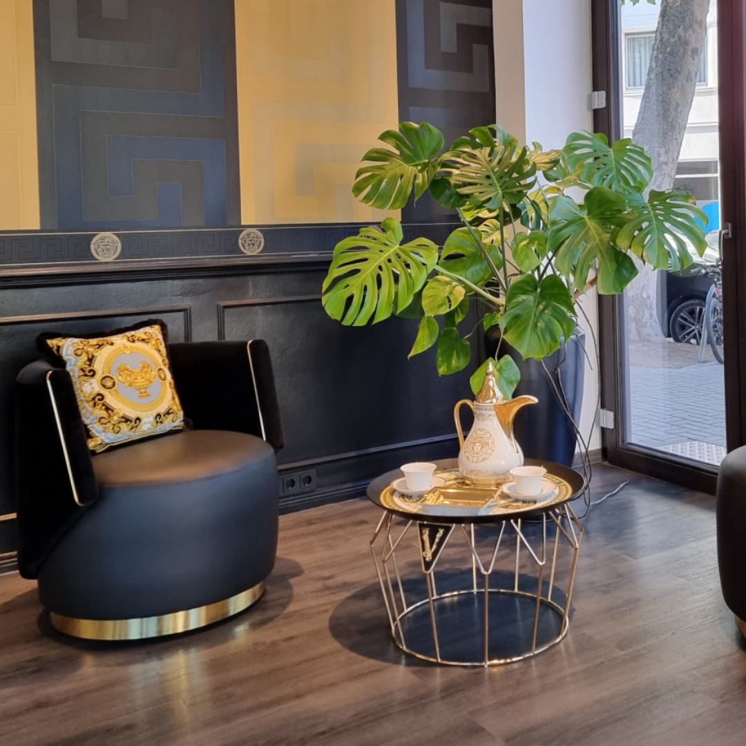 Versace Home furniture with signature Medusa and La Greca detailing, available at Royal Interiors Singapore.